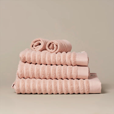 Organic cotton blush pink bathroom towels. Super soft ribbed towels in four sizes: hand towel, bath towel, bath sheet and face cloths.