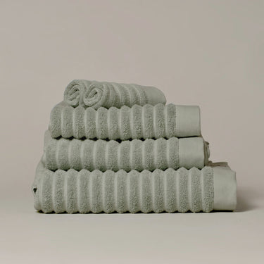 Sage green organic cotton towels for a sustainable bathroom - modern ribbed stripe design.