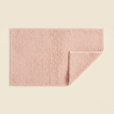 Blush pink bath mat made from organic cotton. Soft and sustainable bathroom accessories.