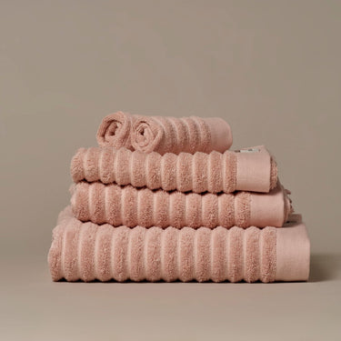 Organic cotton blush pink bathroom towels. Super soft ribbed towels in four sizes: hand towel, bath towel, bath sheet and face cloths.