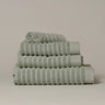 Sage green organic cotton towels for a sustainable bathroom - modern ribbed stripe design.