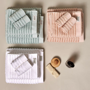 Organic cotton towels for the bathroom in various colours - white, pink, duck egg blue. Mixed size towel bales.