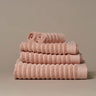 Organic cotton blush pink bathroom towels. Super soft ribbed towels in four sizes: hand towel, bath towel, bath sheet and face cloths. 